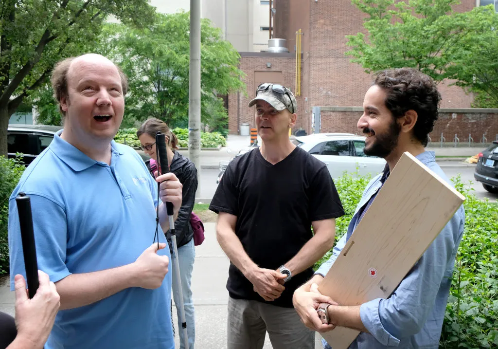 Matt from System Sounds talking with someone from the CNIB outside the planetarium building after the show