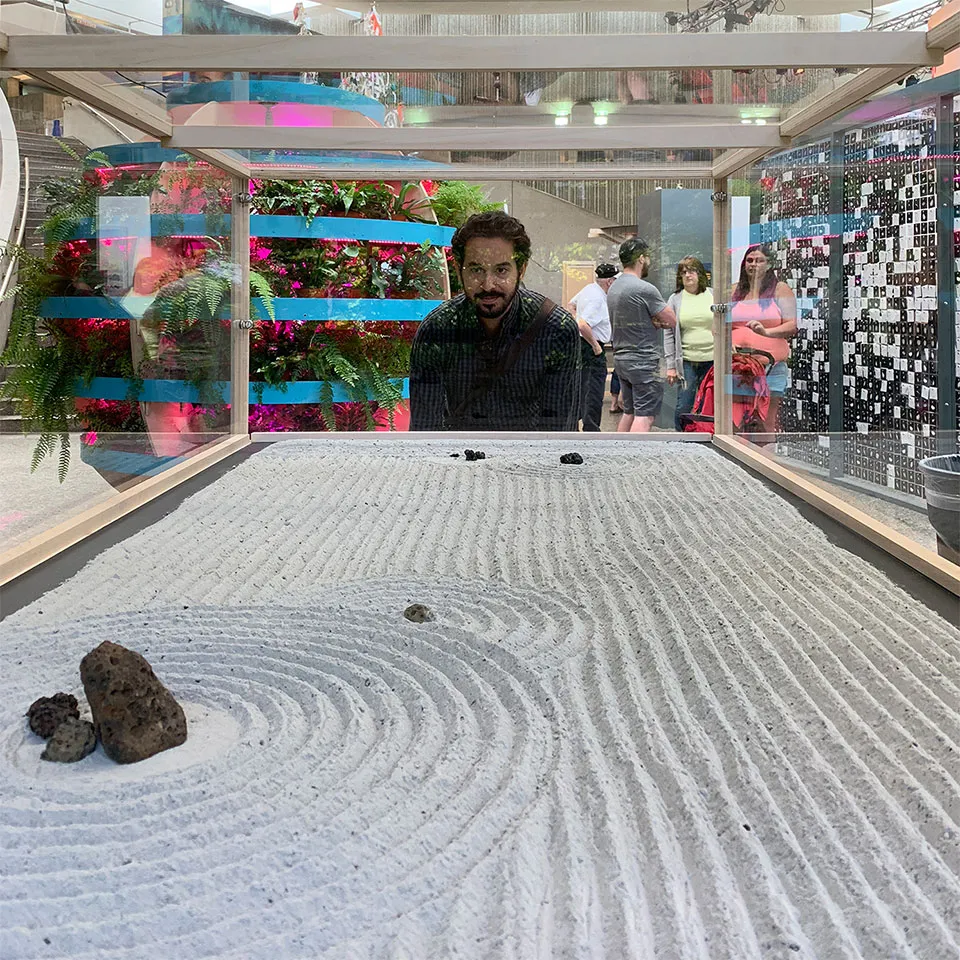 Matt from System Sounds looking through the glass at the Lunar Rock Garden