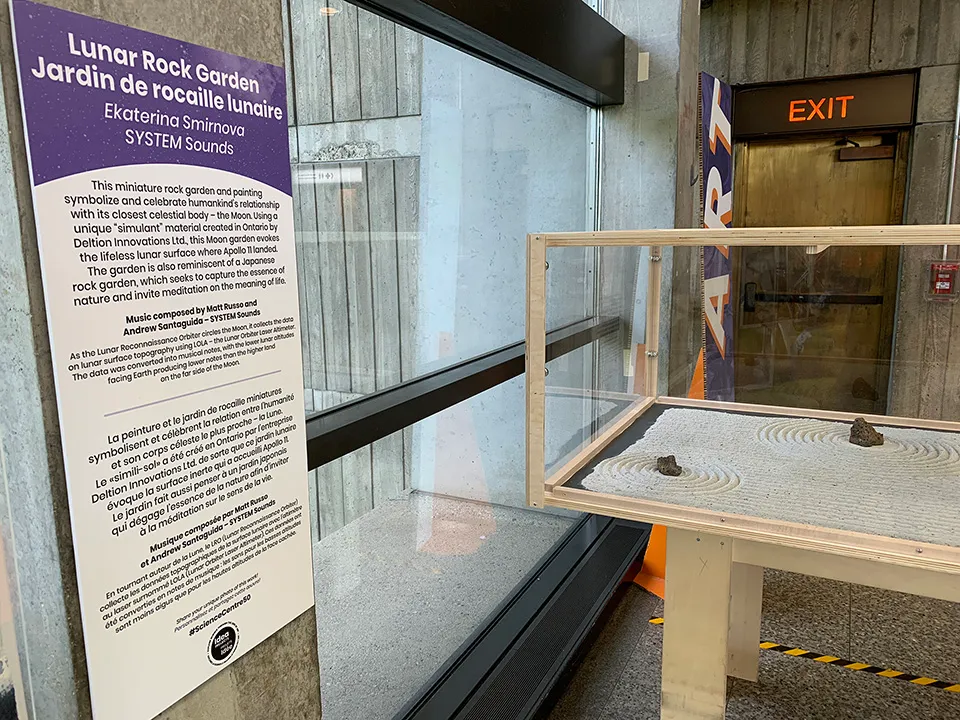 A side view of the Lunar Rock Garden with the signage of the exhibit